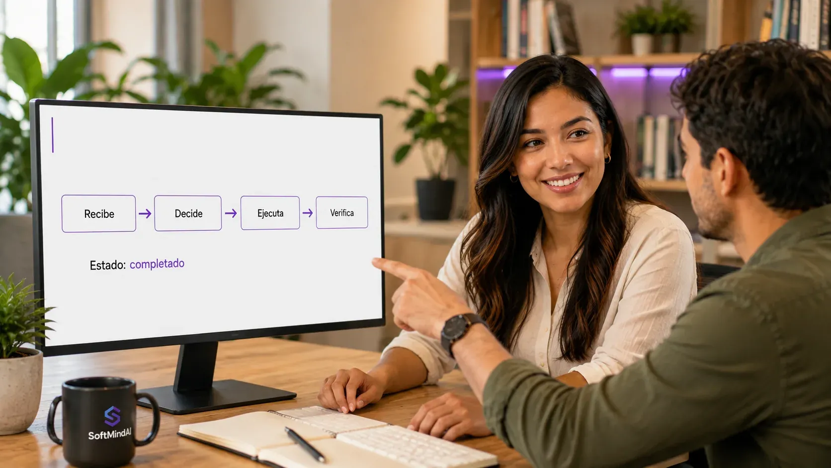 Dos personas revisan un monitor donde un agente muestra su flujo de trabajo: Recibe, Decide, Ejecuta, Verifica, y debajo la línea “Estado: completado”.